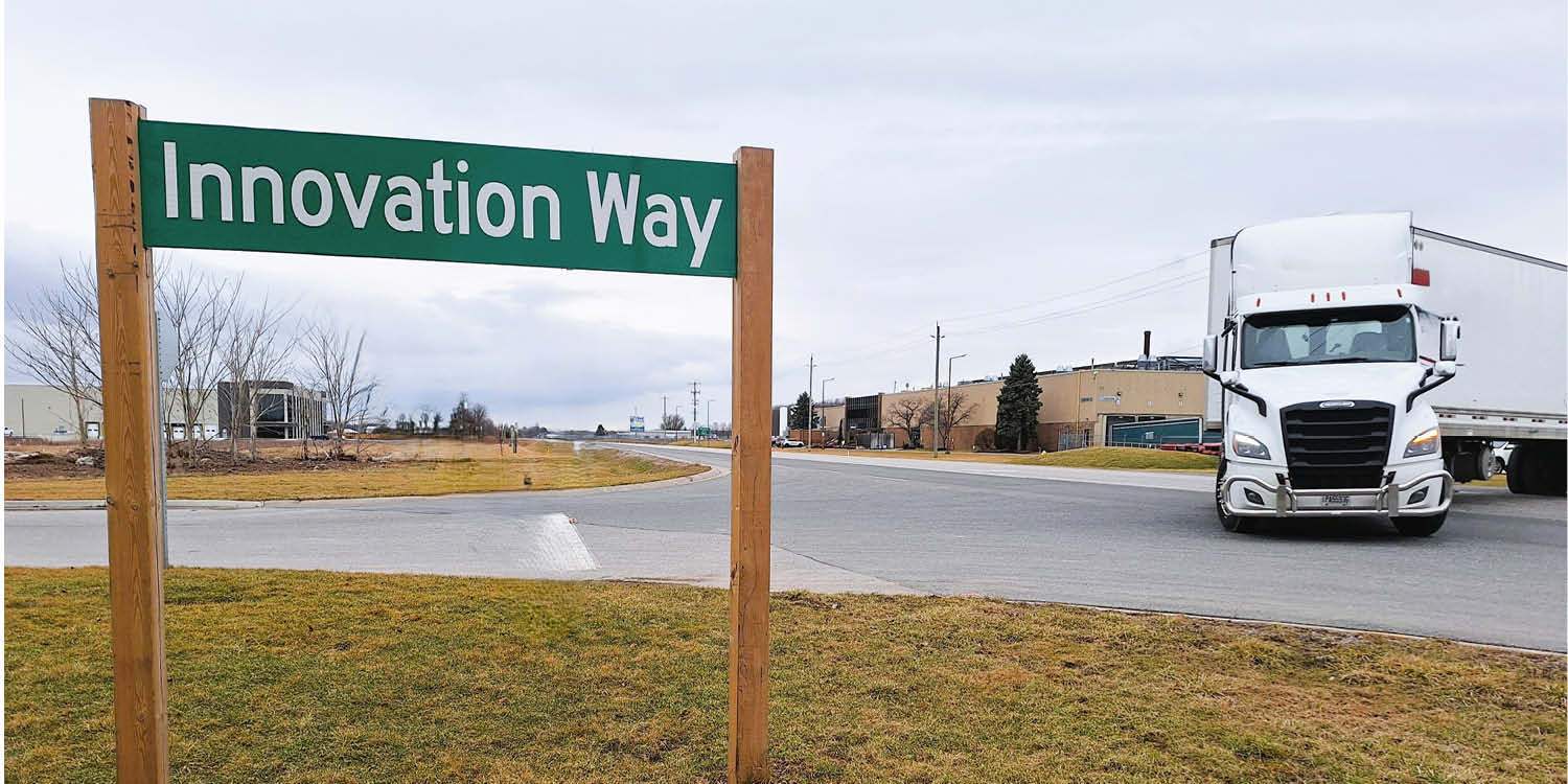 Street corner with Innovation Way sign and tracker trailer